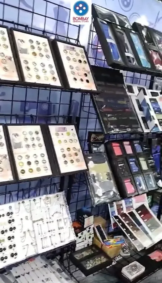 Inside the shop — walls of button cards and trims at the Bandra counter